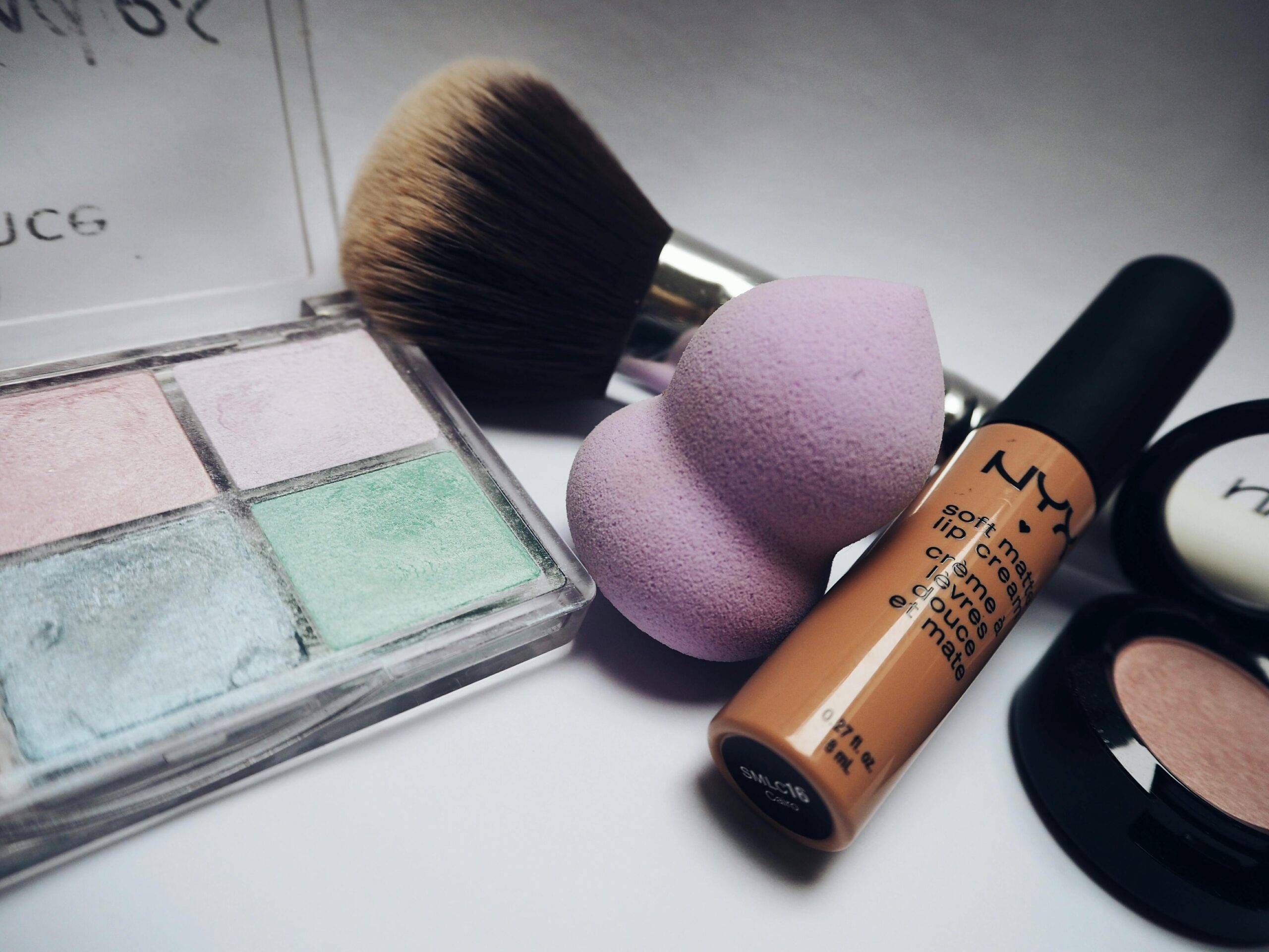 pexels photo 234220 234220 A flat lay showcasing various makeup essentials including brushes, sponges, and cosmetics.